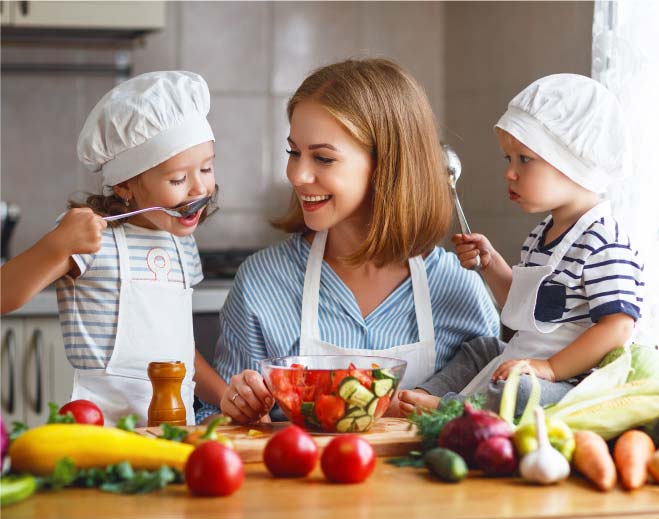 Family preparing fresh meal together in kitchen