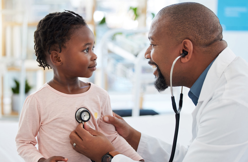 Clinician using stethoscope to examine child
