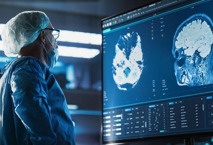 Surgeon reviewing detailed brain scans