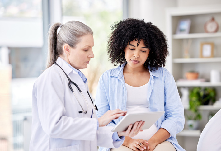 Clinician reviewing tablet with patient