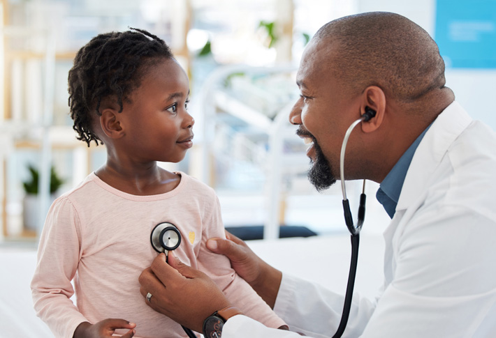 Doctor using stethoscope on young child