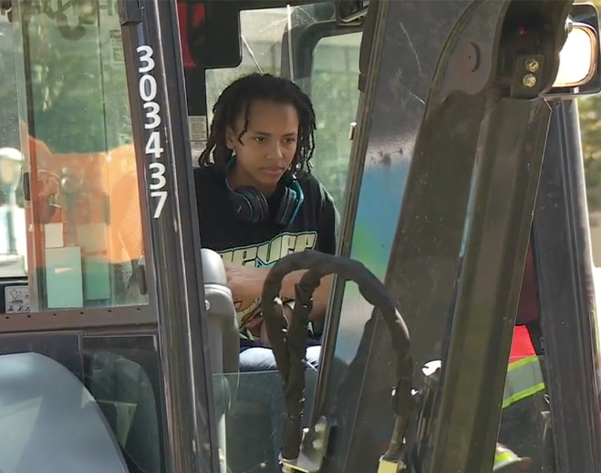 Child seated inside construction vehicle