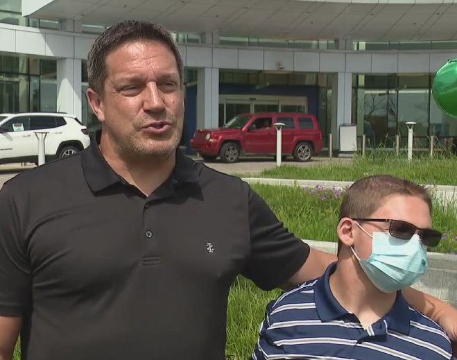 Adult and child outside hospital