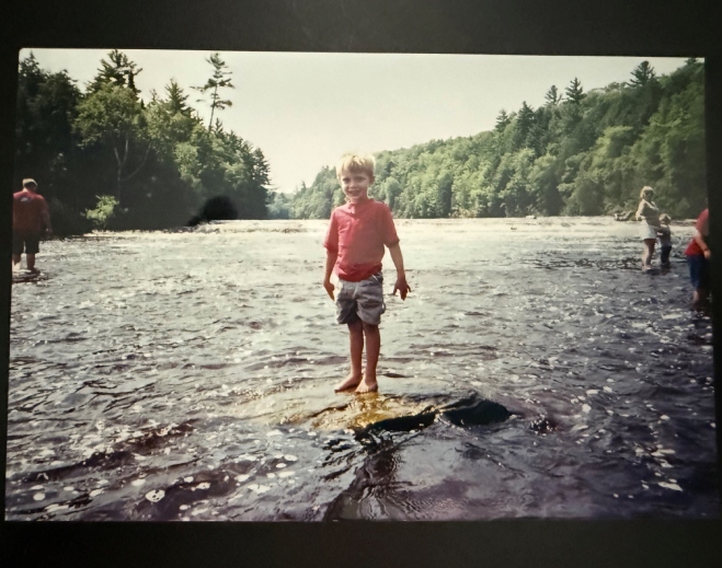 Child standing in shallow river