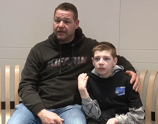 Adult seated beside child indoors