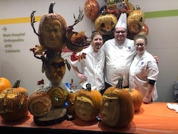 chefs posing with pumpkins