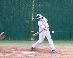 boy hitting baseball