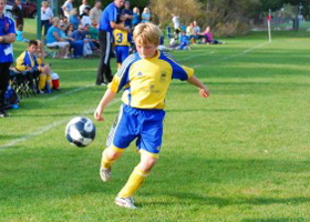 boy kicking soccer ball